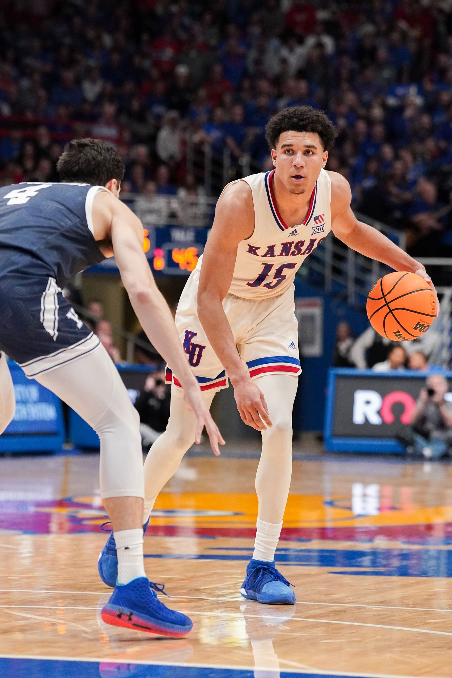 Dec 22, 2023; Lawrence, Kansas, USA; Kansas Jayhawks guard Kevin McCullar Jr. (15) dribbles the ball as Yale Bulldogs guard John Poulakidas (4) defends during the second half at Allen Fieldhouse. Mandatory Credit: Denny Medley-USA TODAY Sports  